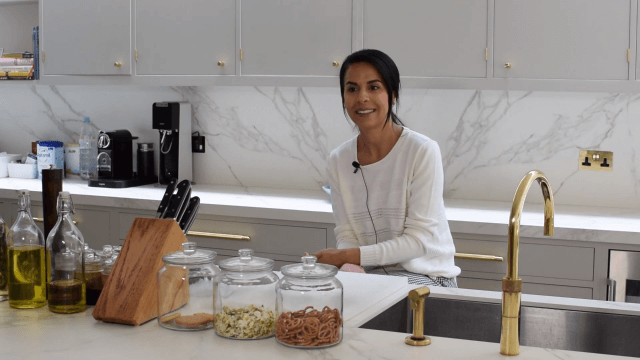 Woman in tidy kitchen smiling