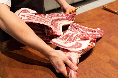 Butcher cutting locally produced meat