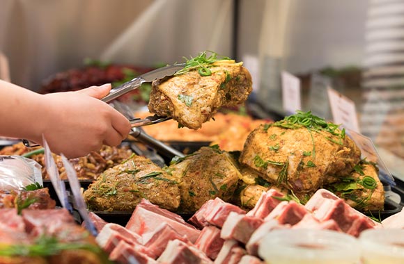 Butcher selling chicken fillet