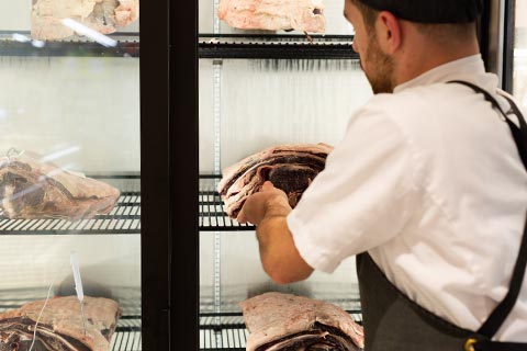 Butcher taking meat out of freezer