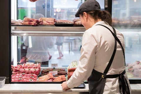 Butcher preparing meat for Malvern store