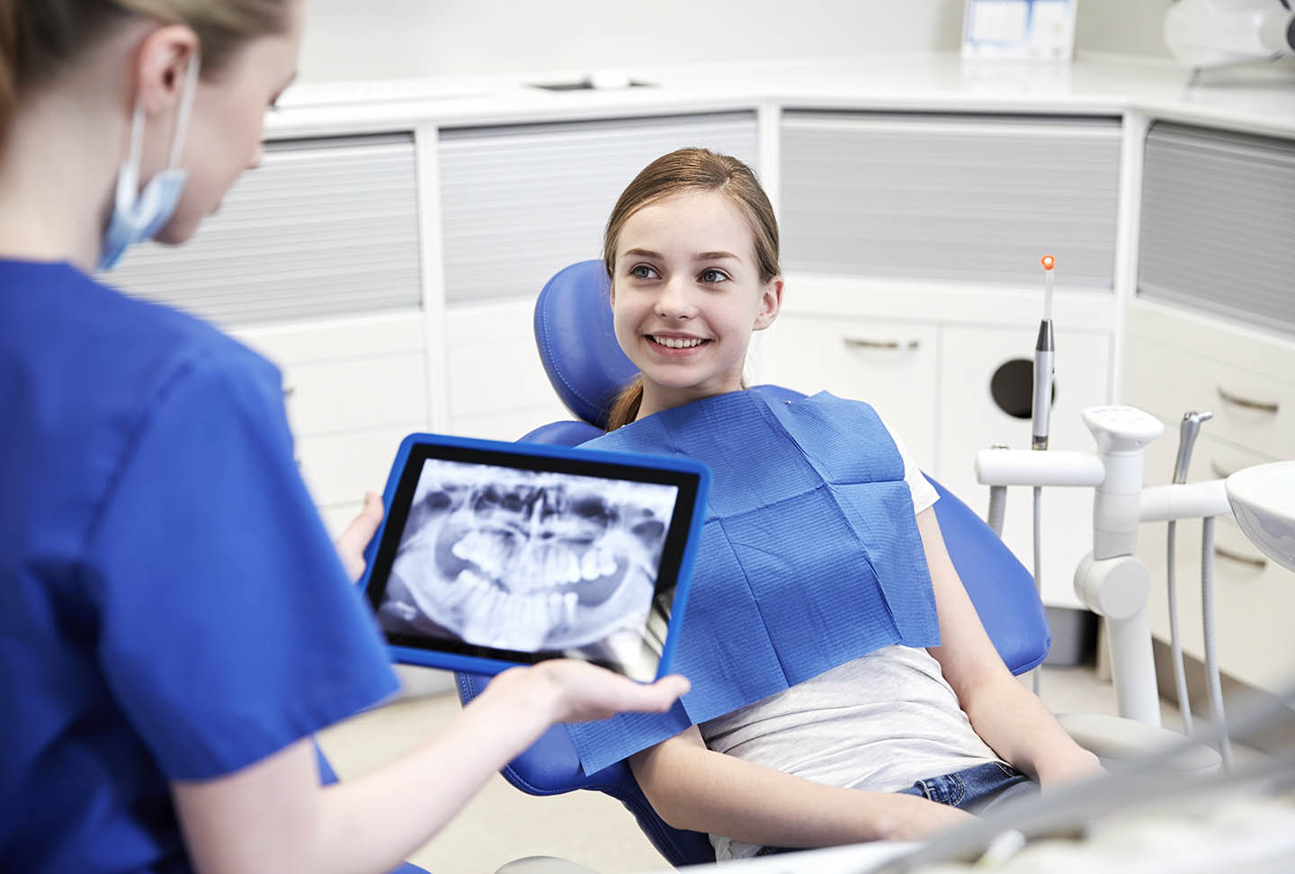 young girl smiling in dentist chair