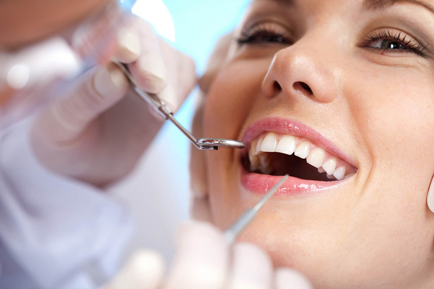 dentist demonstrating how to brush teeth
