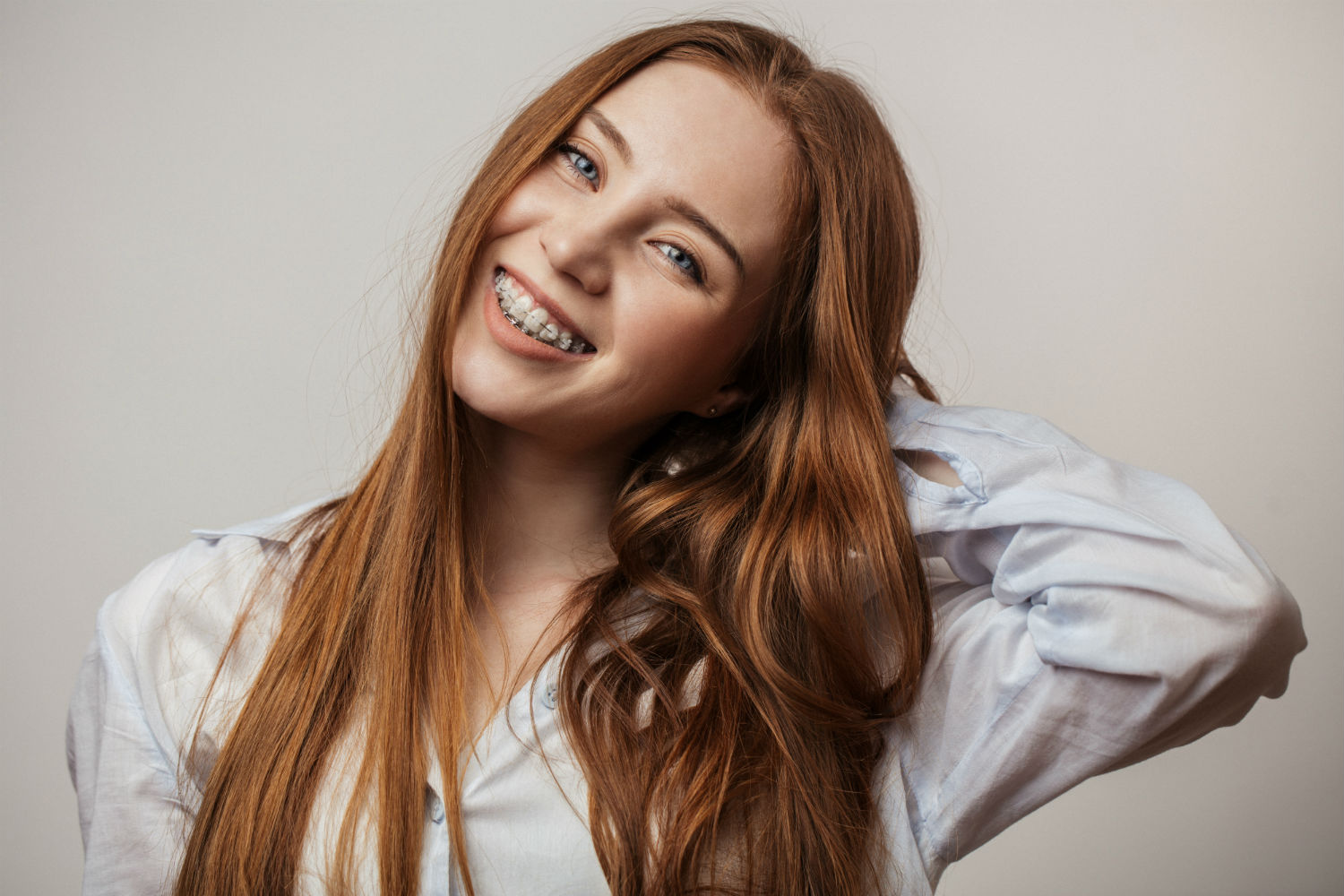 A patient embraces her braces