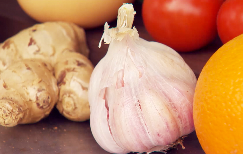 The superfood garlic surrounded by fruits.