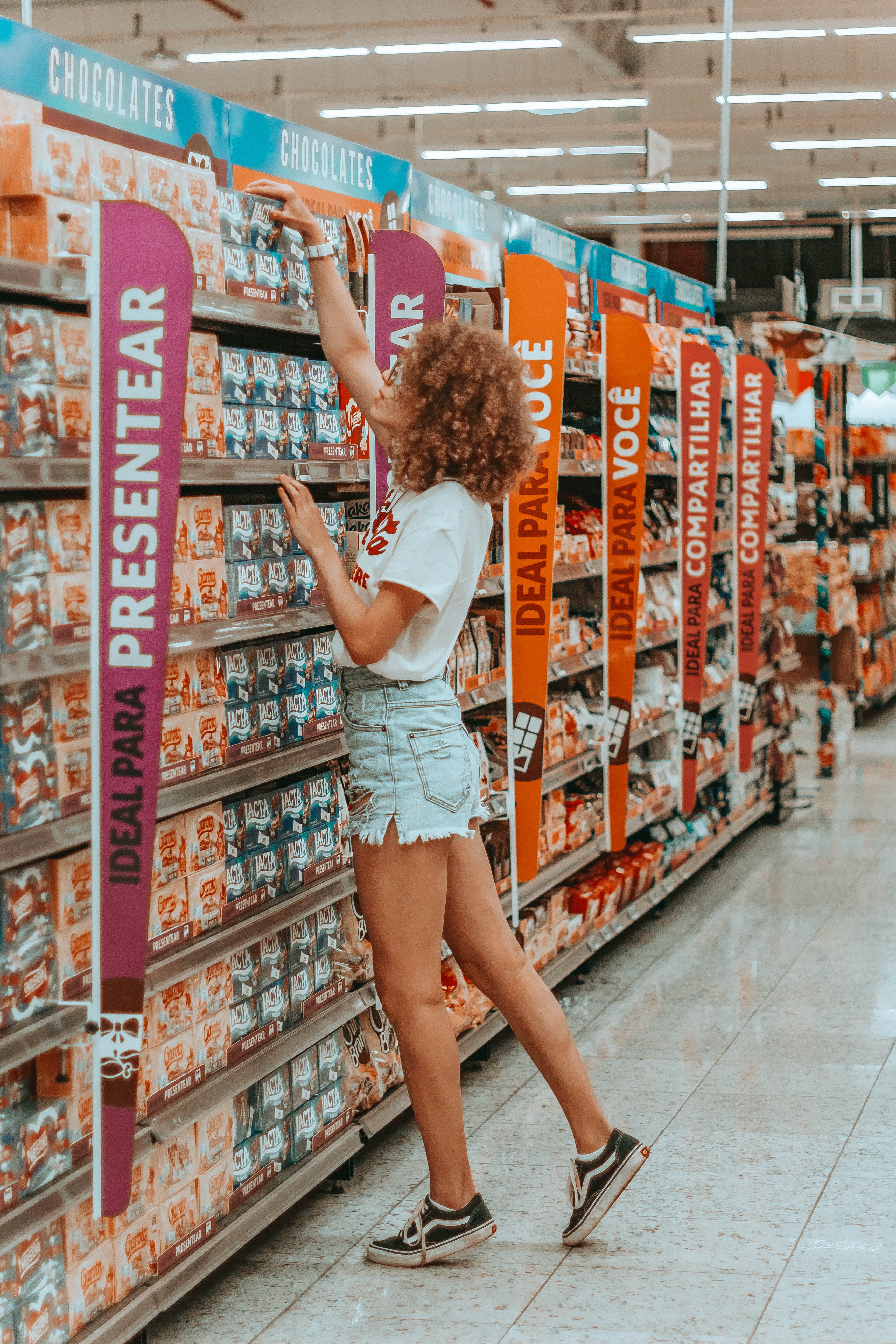 Value of Variety and Choice Overload in Customer Psychology - a woman reaching for a product on a shelf