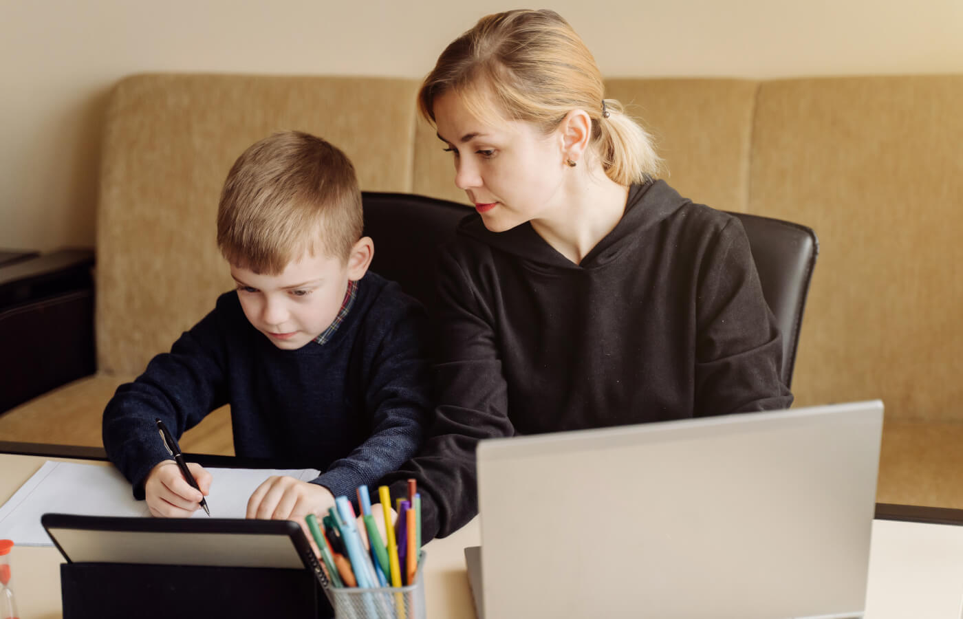 mother helps son with online learning