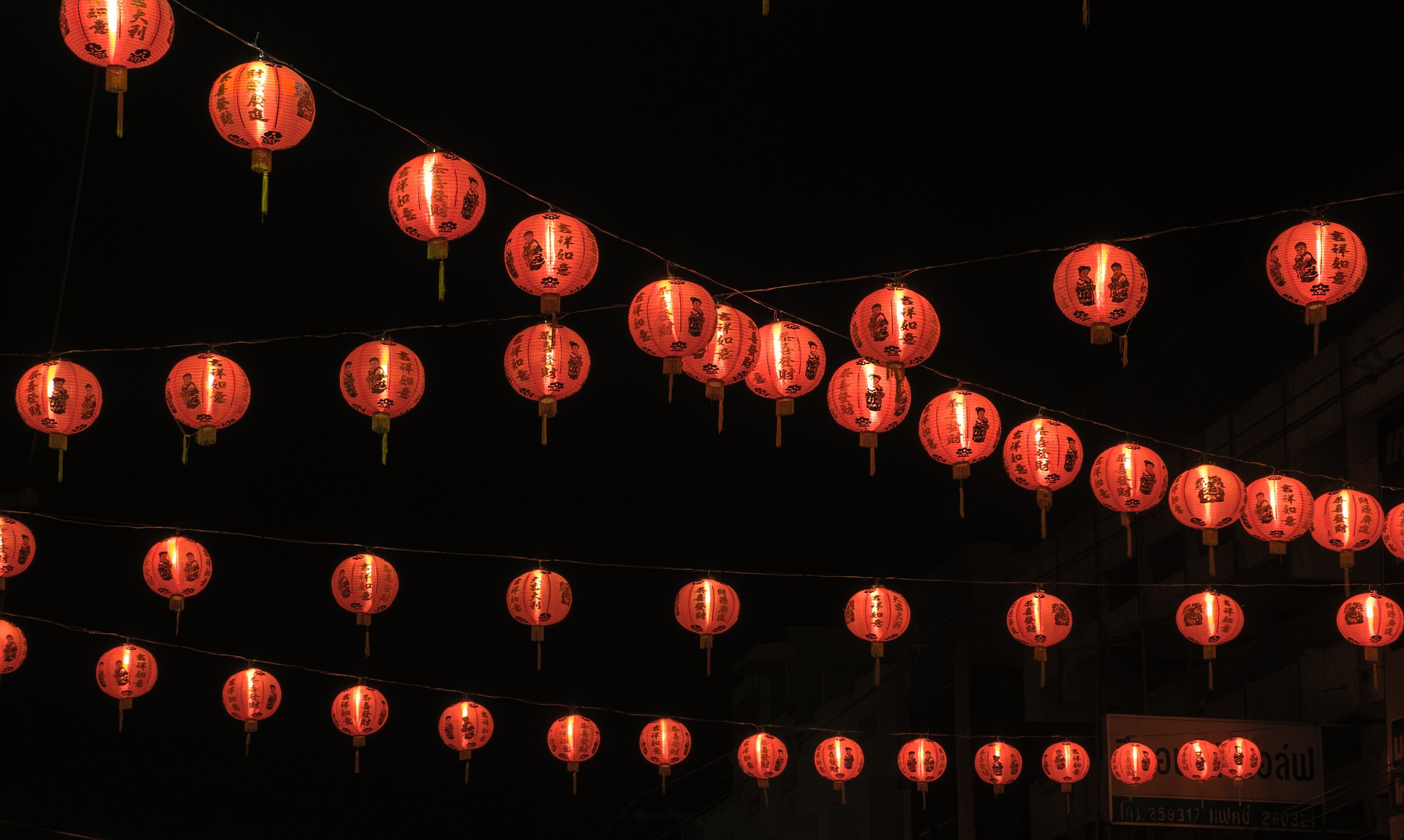 orange sky lanterns on a black background to show how colour can be strong in branding