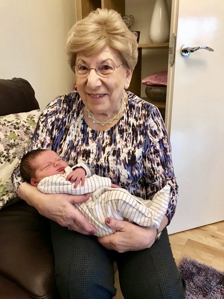 Older adult holding small baby