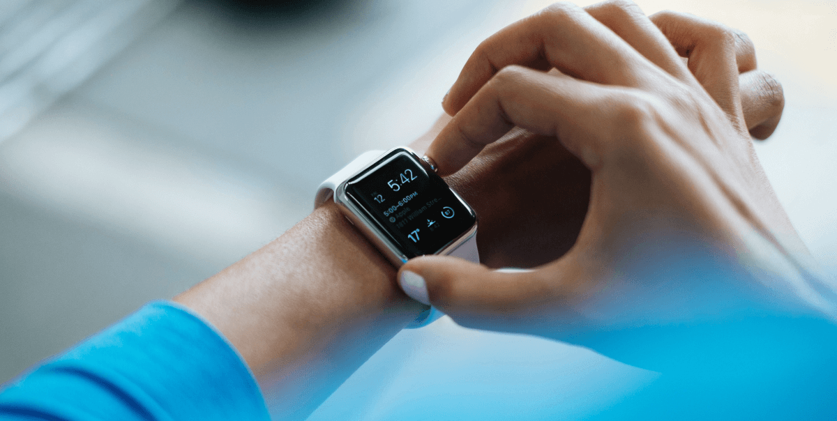 Woman in blue top uses a smart applewatch