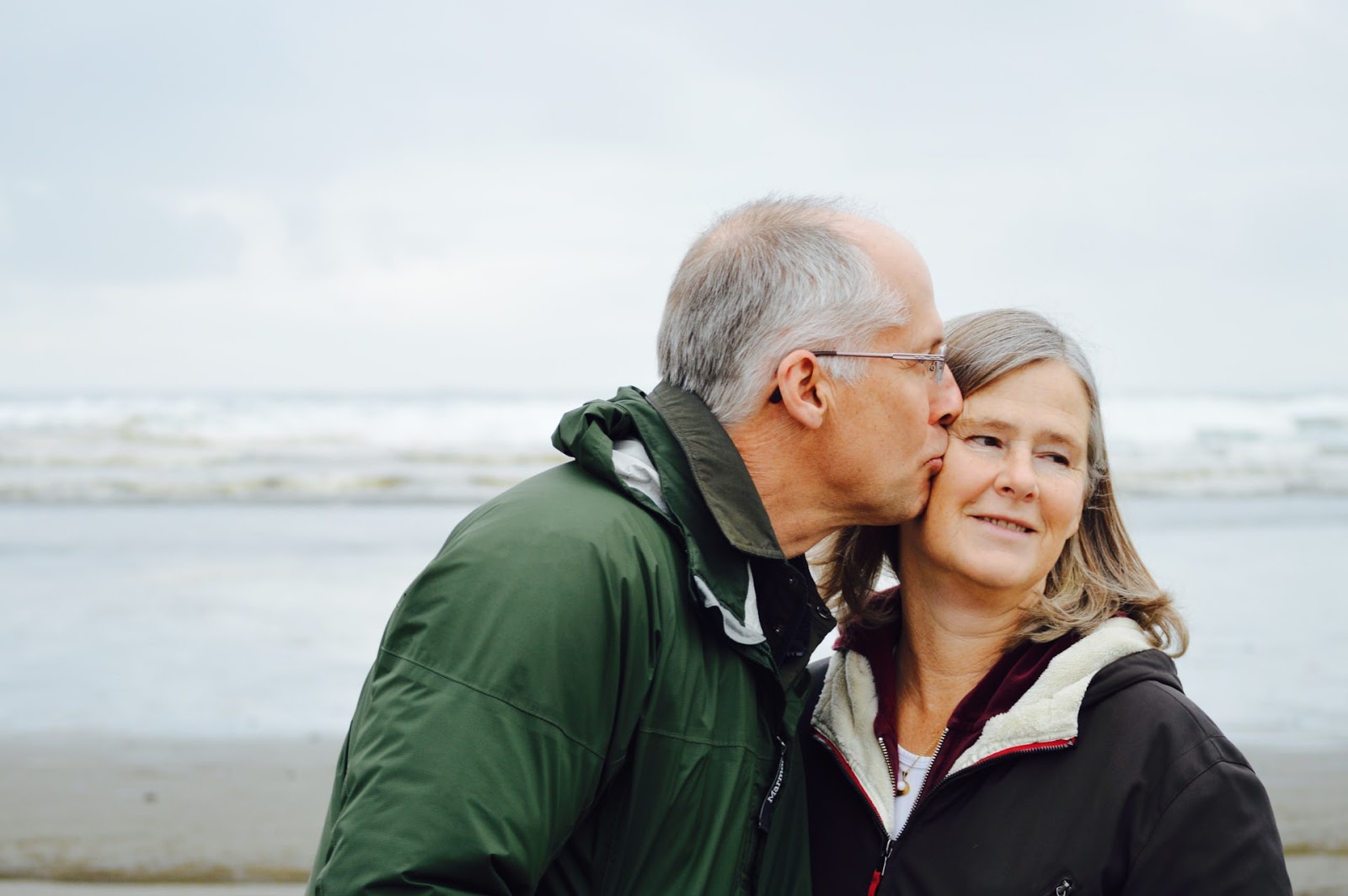 elderly man kissing wife