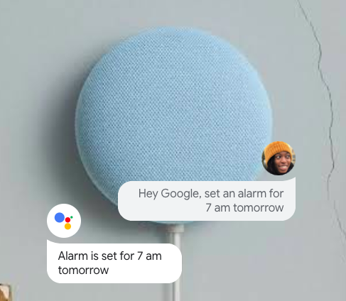 A Google Nest Mini with a dialogue box showing how you can ask it to set an alarm tomorrow.
