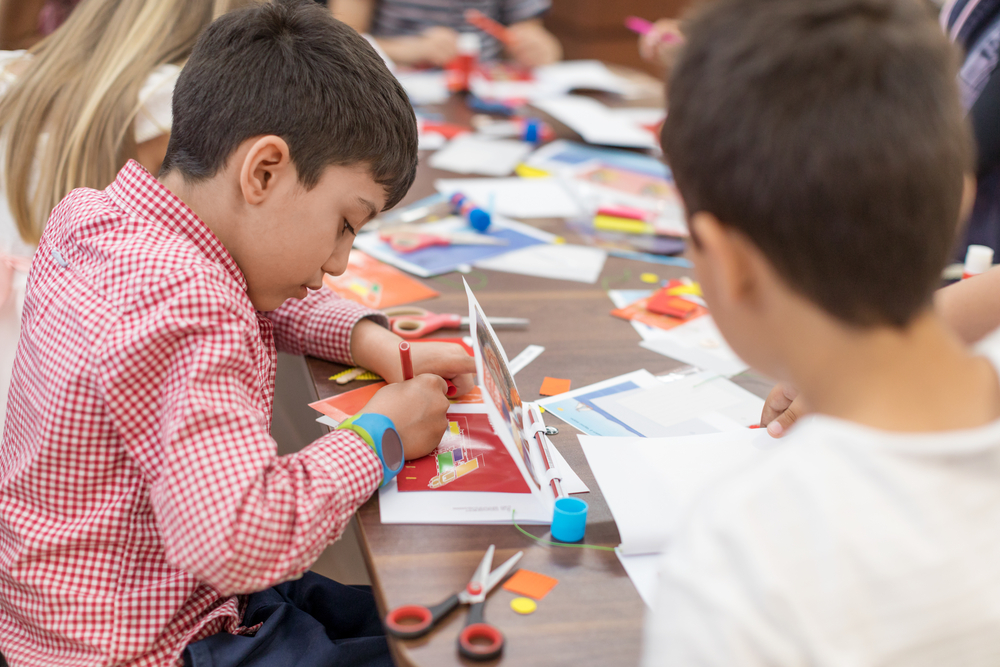 A kid doing arts and crafts.