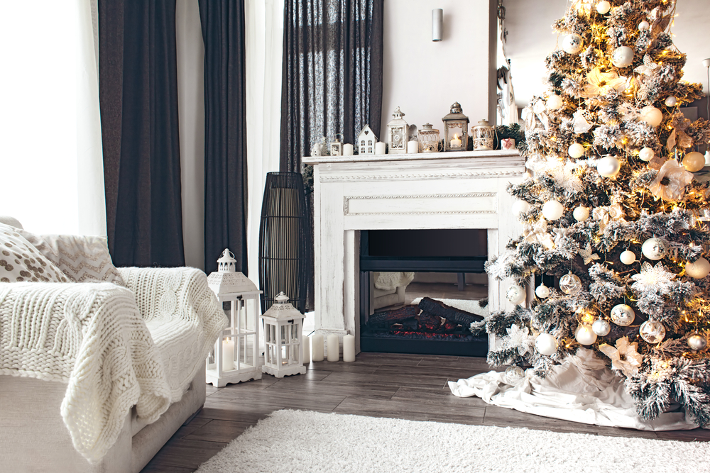 A living room decorated in white and gold for Christmas.