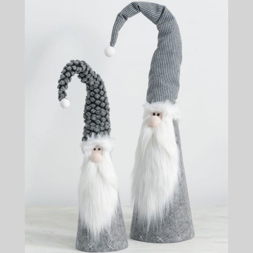 Two Santa dolls with long, whimsical hats.
