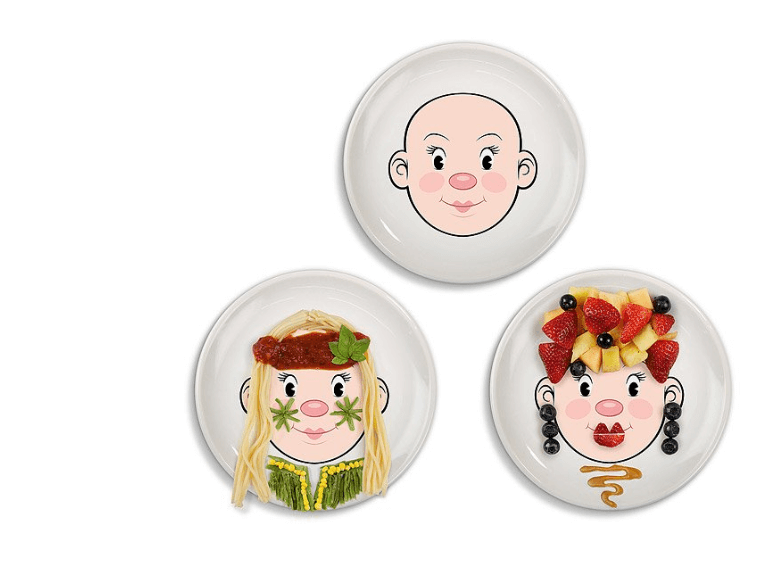 Three plates with faces on them so kids can play with their food.