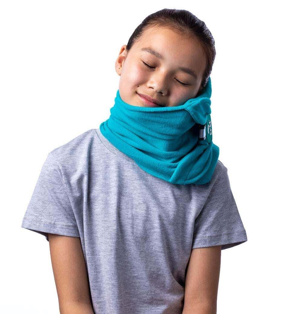 A young girl sleeping with a trt neck blanket.