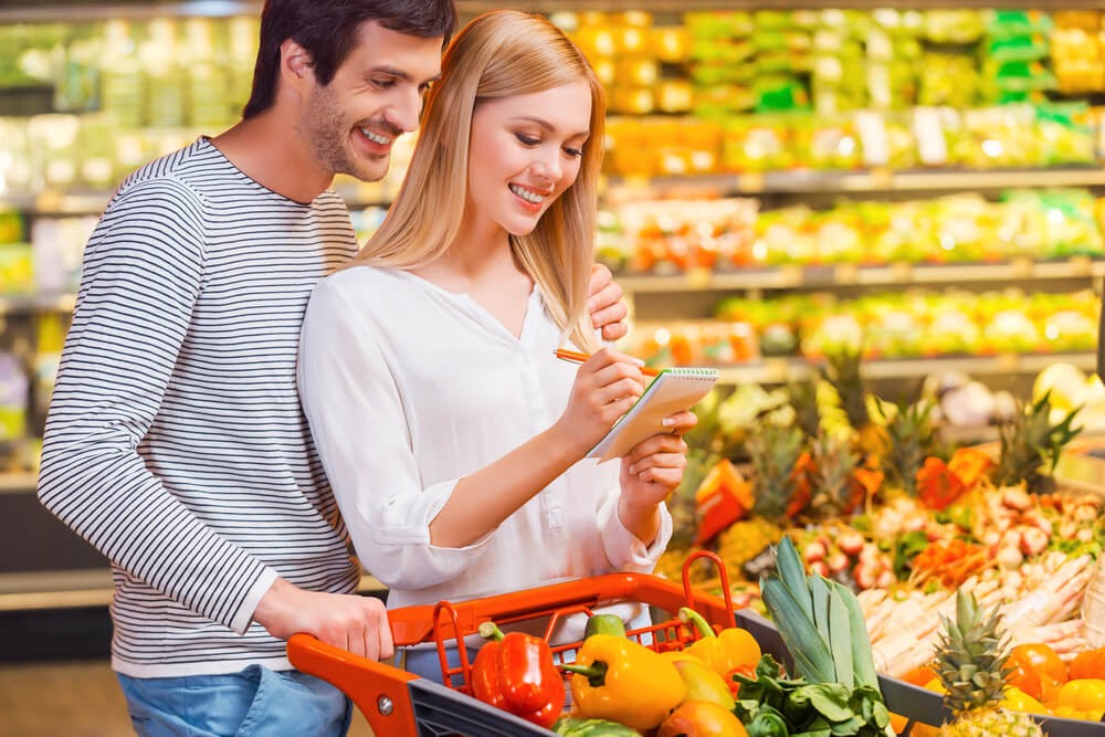 couple looking at grocery store list