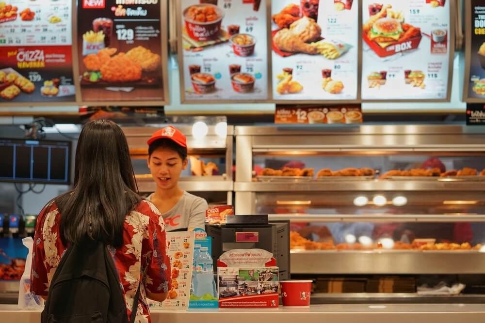 Woman at counter ordering KFC