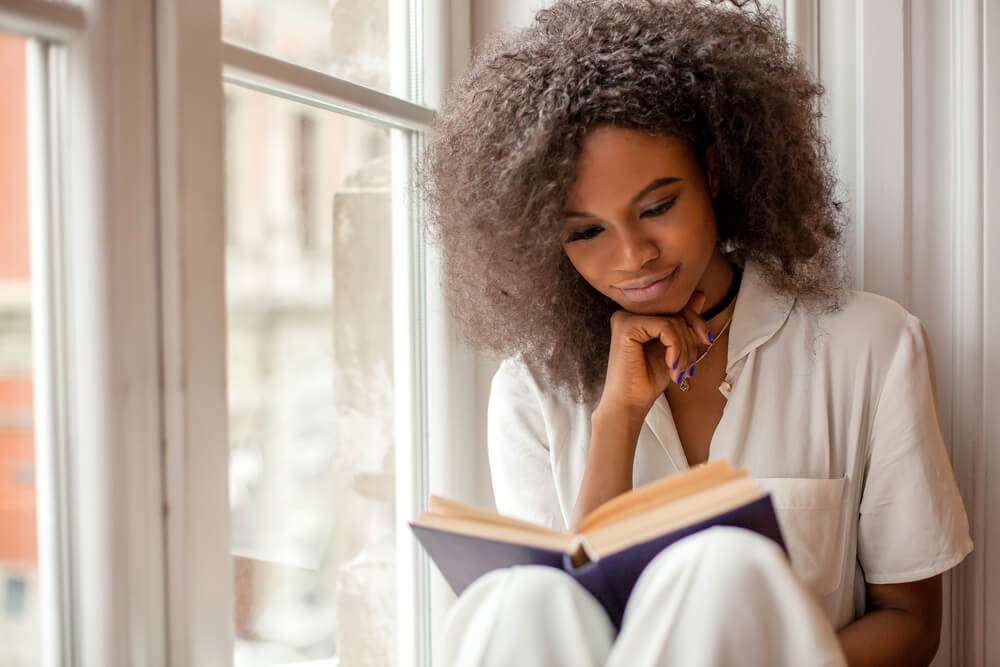 Woman reading in window