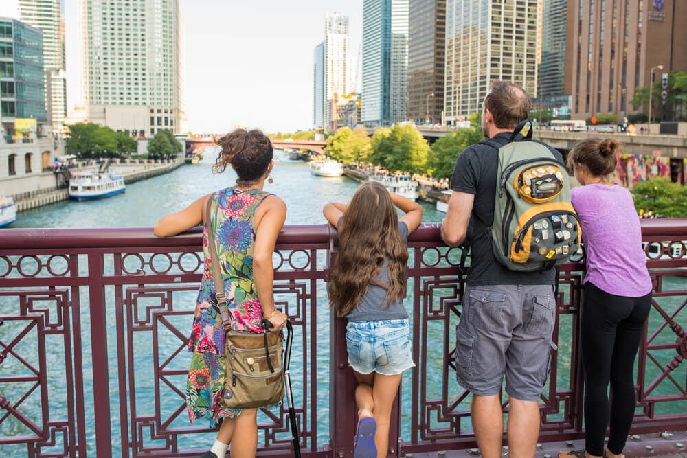 Family looks over water from bridge