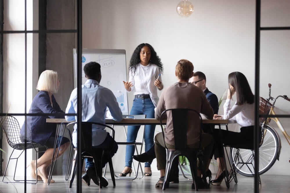 Woman giving presentation to group of people