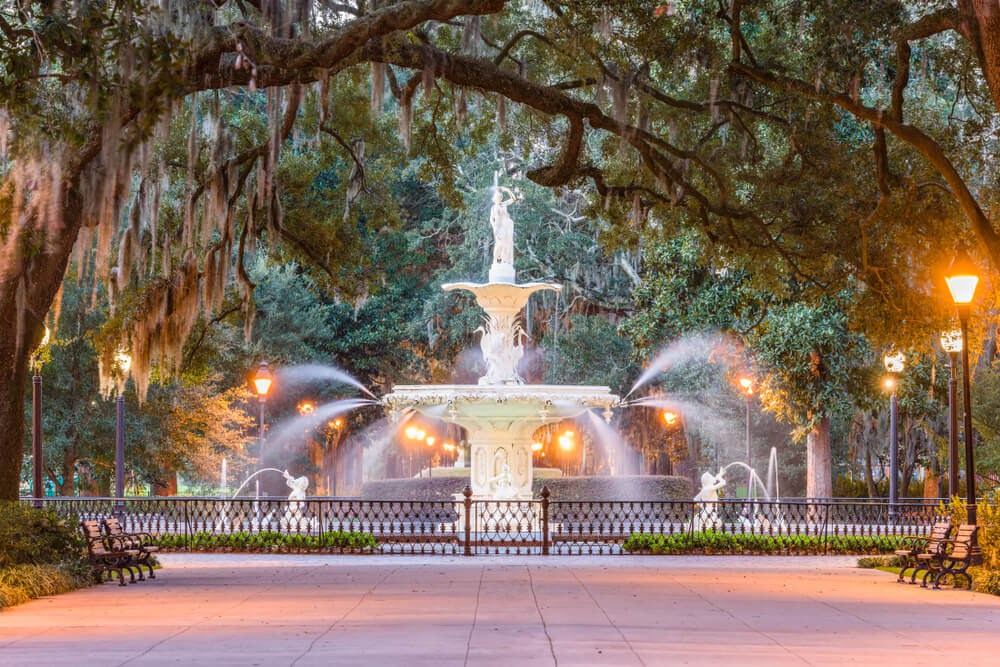 Forsyth Park fountain in Georgia. Large fountain under trees covered in moss