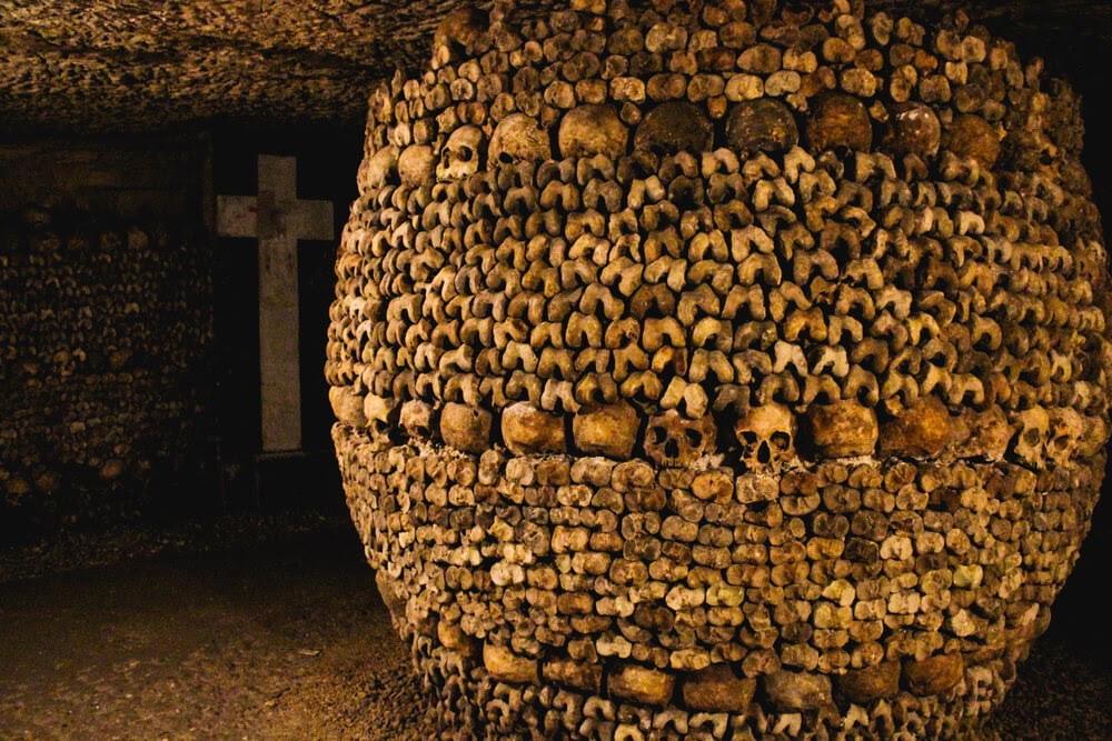 Catacombs of Paris in France. Walls made of skulls and bones.