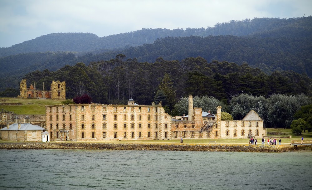 Remnants of a large golden brick building in Port Arthur, Australia.