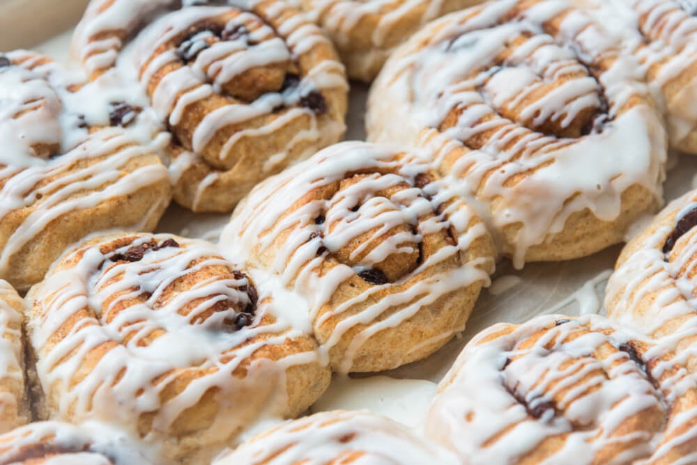 Close-up shot of iced cinnamon rolls.