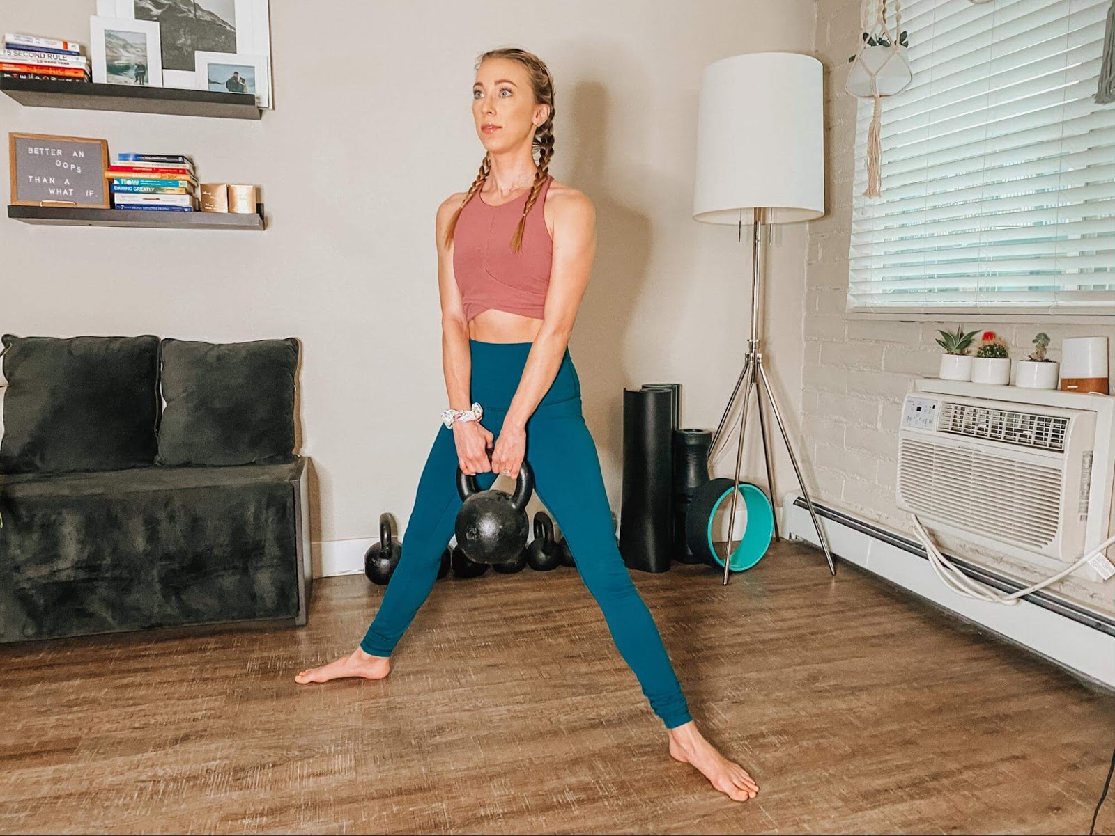 Woman performing Sumo squat with kettlebell
