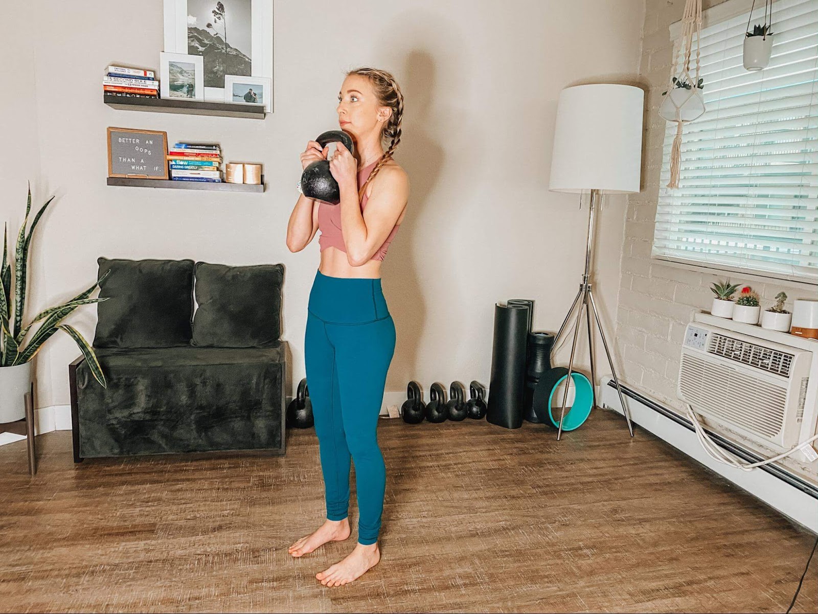 Woman performing goblet squat with kettlebell
