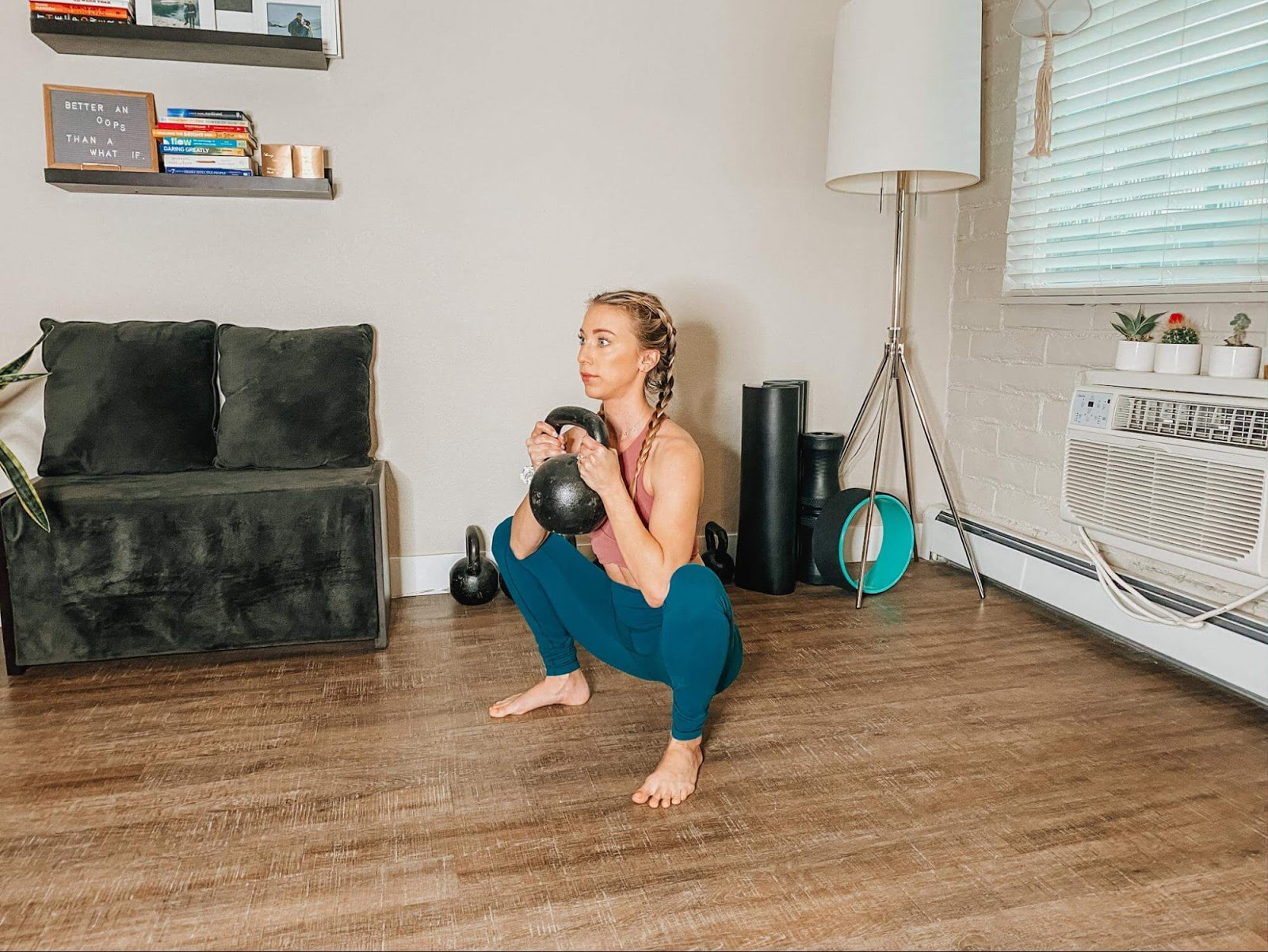 Woman performing goblet squat with kettlebell