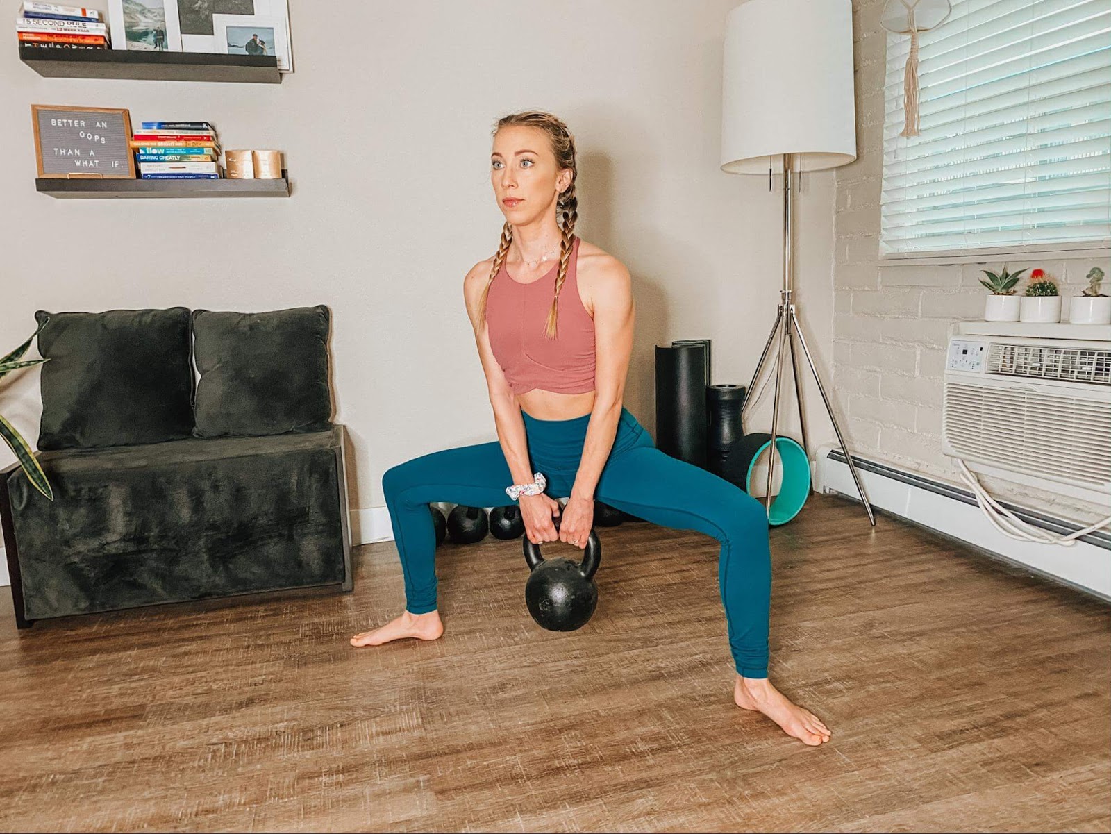 Woman performing Sumo squat with kettlebell