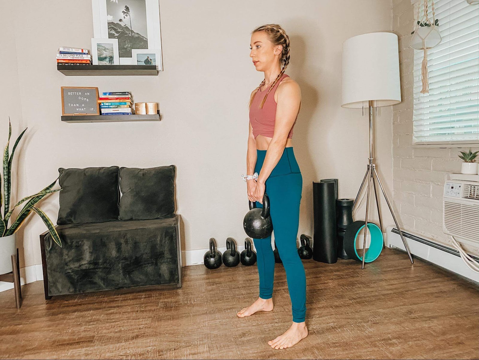 Woman performing deadlift with kettlebell
