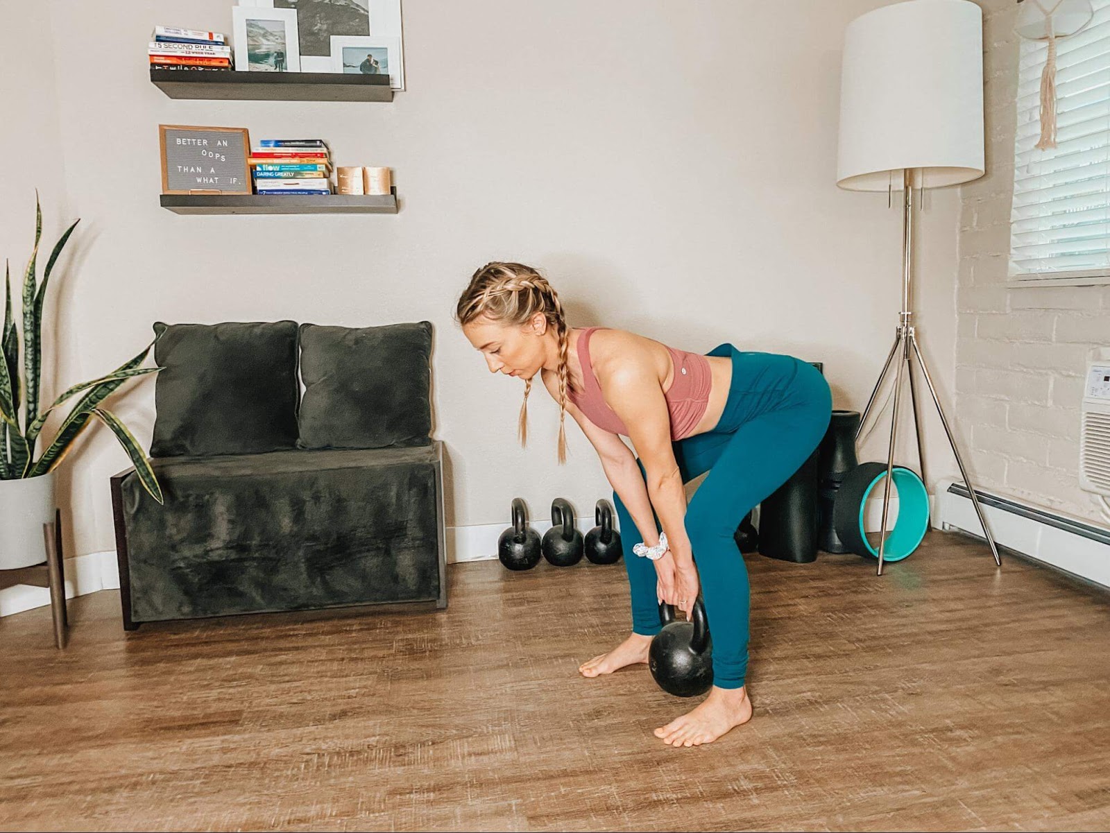 Woman performing deadlift with kettlebell