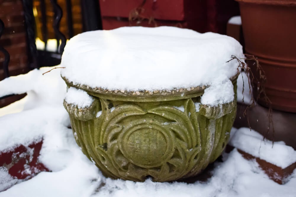Decorative pot covered in snow.