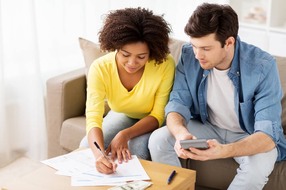 Couple sitting down doing paperwork