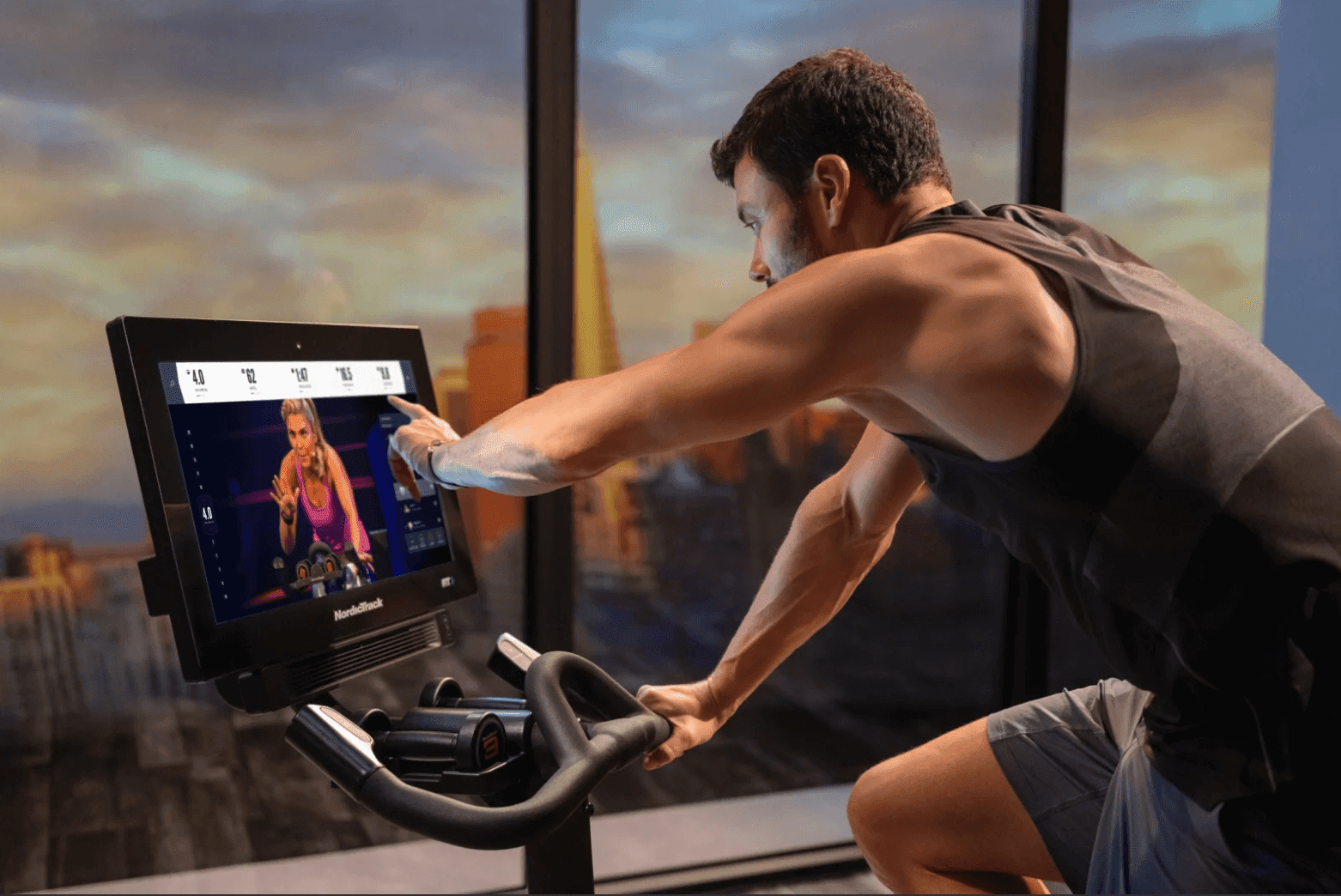 Man on exercise bike with digital screen.