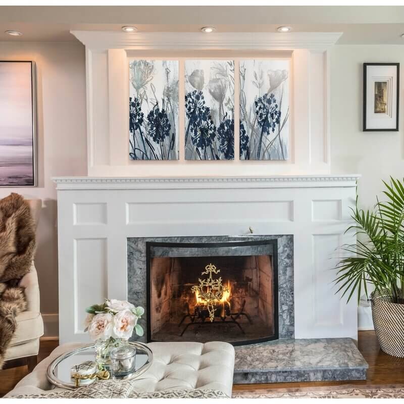 Three piece floral panel hung above a fire place.
