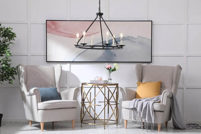 Two white chairs sit next to a gold table.