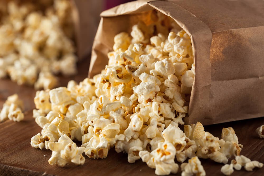 Brown bag filled with popcorn.