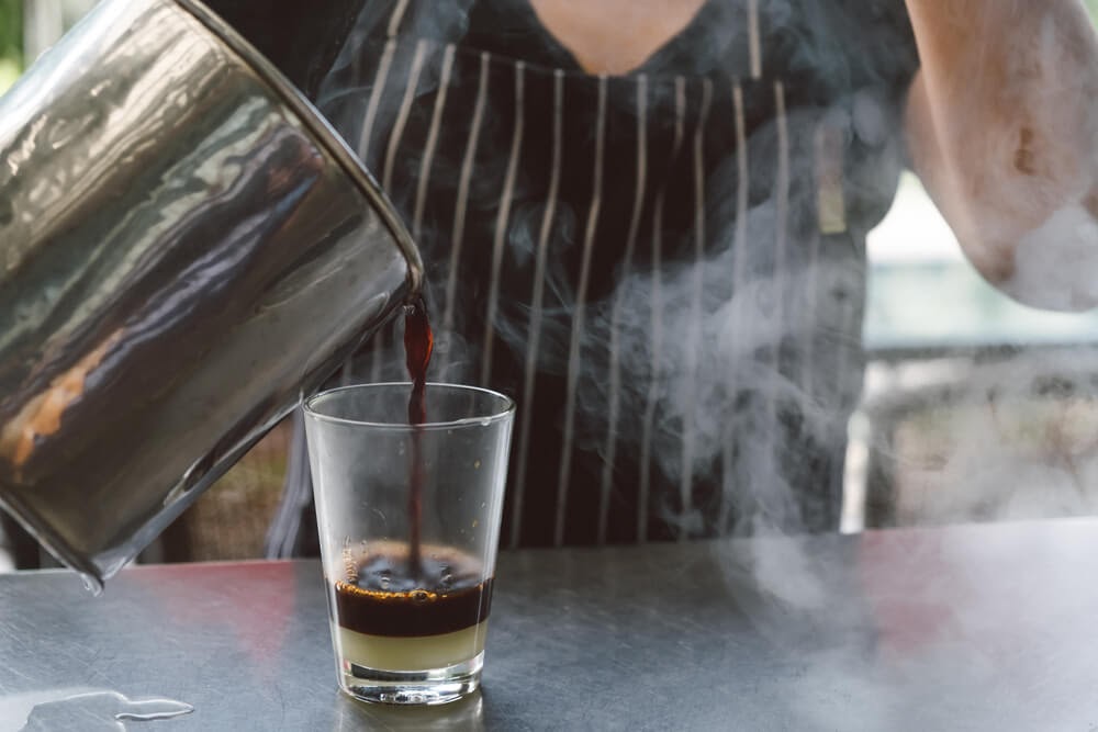 woman pouring coffee into cup