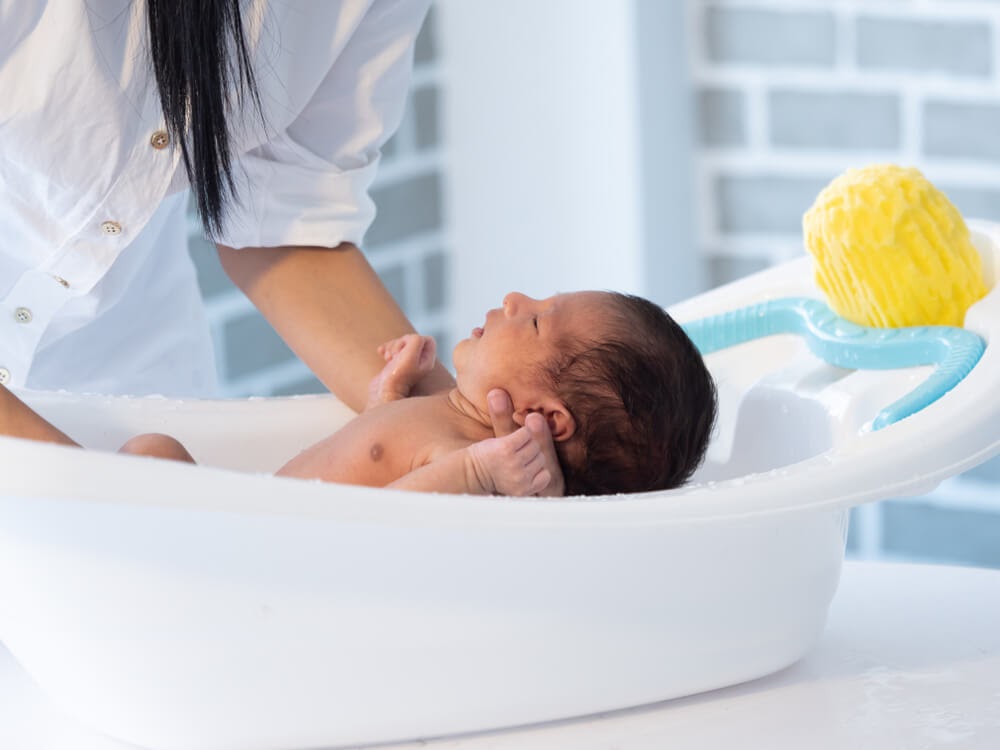 Woman giving baby a bath