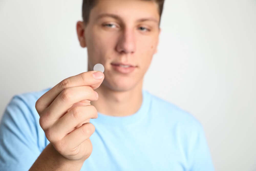 Man holding acne patch