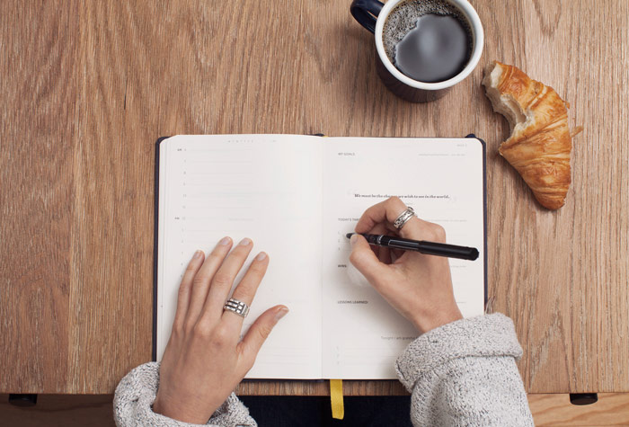 College student planning life lessons over coffee and croissant