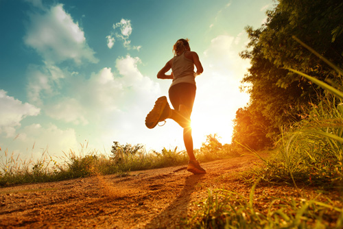 Running toward sun through a field for mental clarity.