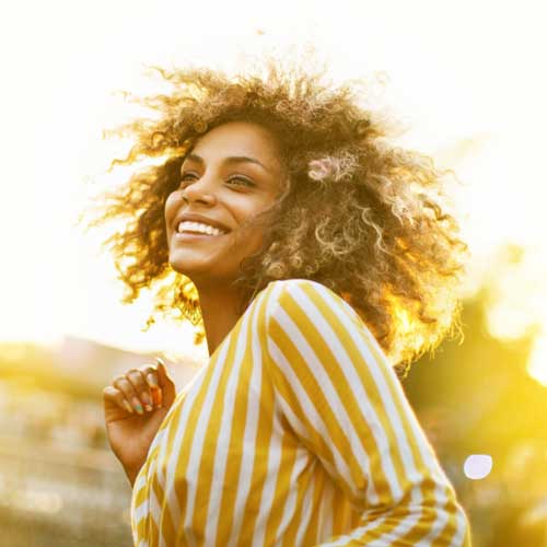 Woman dancing in the sunlight
