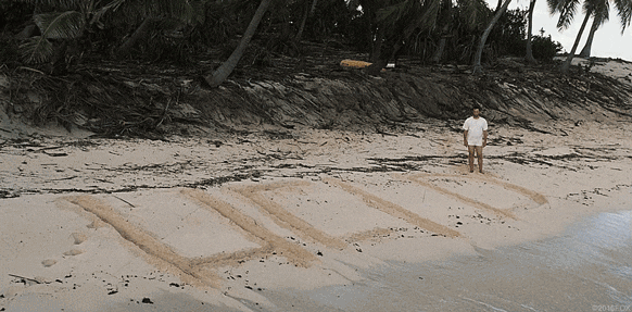 An animated gif from the movie "Castaway" depicting Tom Hanks on a beach with "HELP" written in sand.