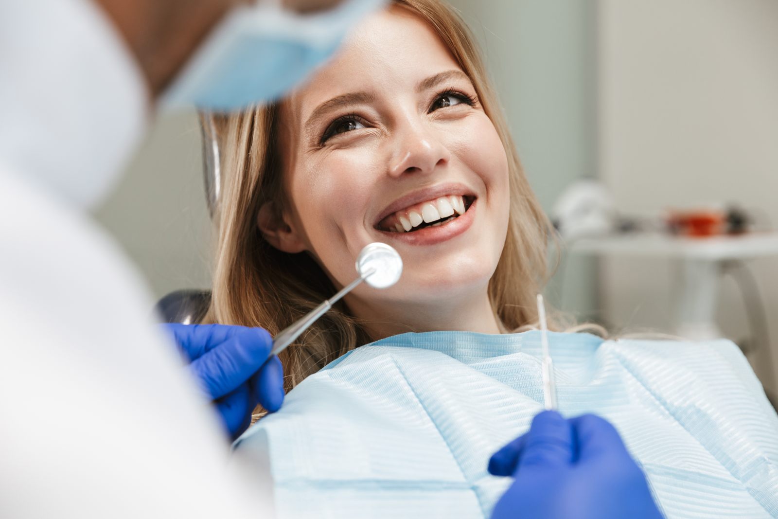 woman patient smiling up at dentist